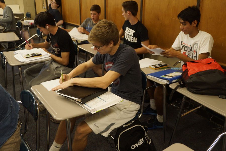 Students work on homework in Integrated Math 3 during fourth hour.