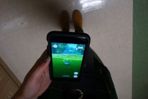 A student attempts to catch an Oddish in the halls of Washburn Rural.