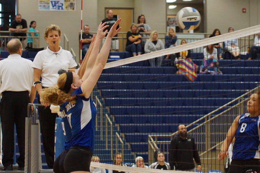 Sophomores Shelby Ebert and Sydney Houser go up for a block during the WRHS Invitational on Sept. 24. 
