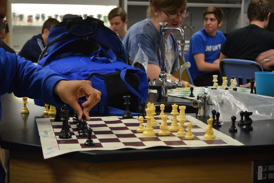 A student moves a piece during Chess Club on Dec. 14.