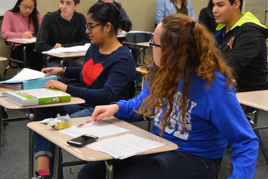 Junior Rachelle Kaur and Junior Cheyanne Colwell get out their materials for class during third hour on Jan. 10.