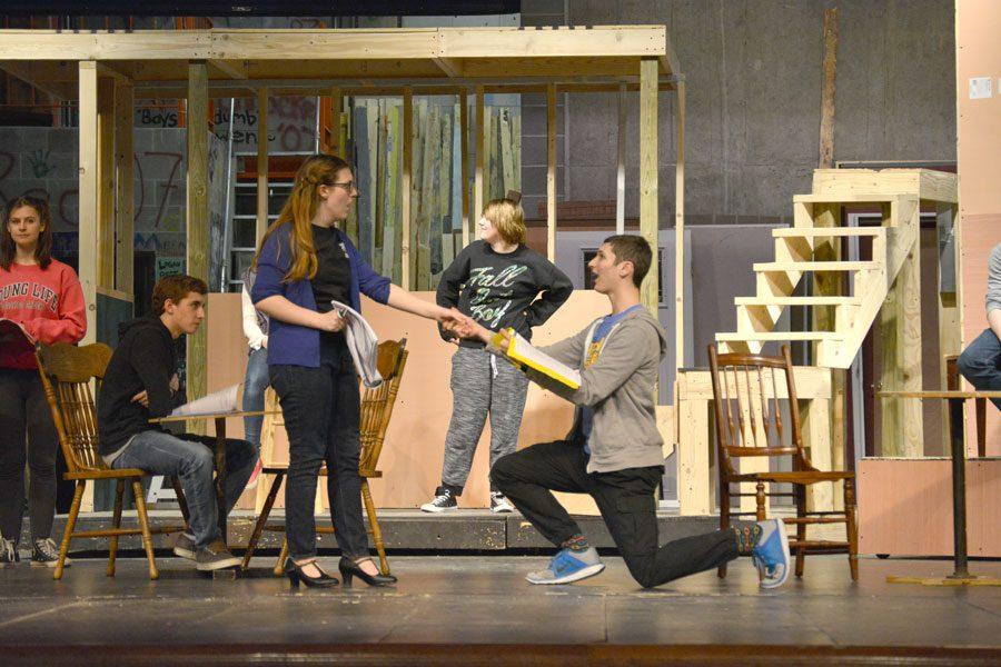 Senior John Katz, who plays Bobby Child, kneels and proposes to Polly Baker, who is played by senior Shannon Nelson during rehearsal on Jan. 12.